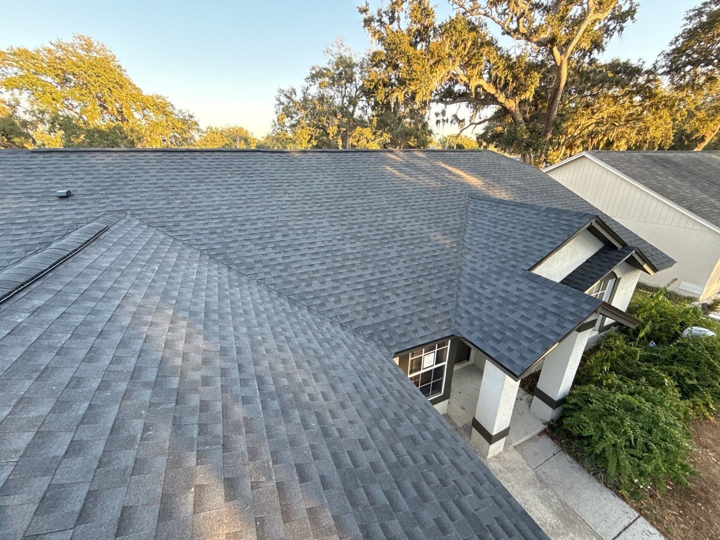 Aerial view of a newly installed gray architectural shingle roof on a Florida home